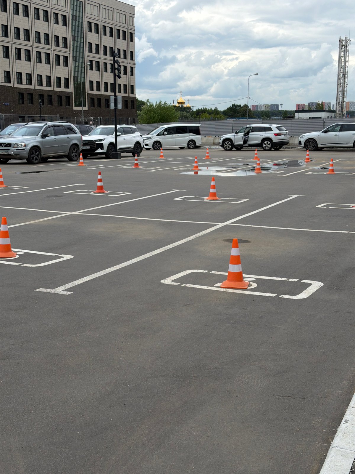 Coned-off parking lot under grey Moscow skies