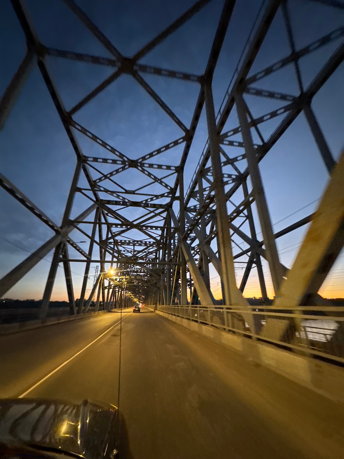 Steel truss bridge in Krasnoyarsk, inside and underneath at dusk