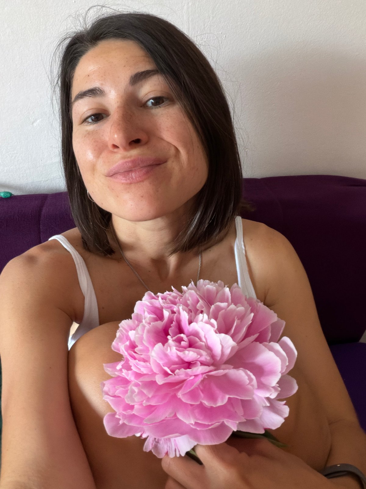 Woman and child pose with pink peonies in Budva