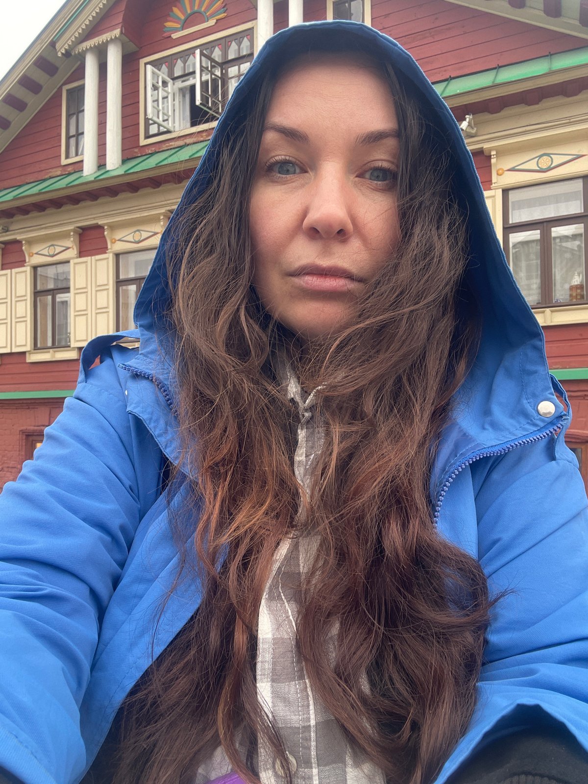 Woman photographs herself near decorative buildings in Kazan