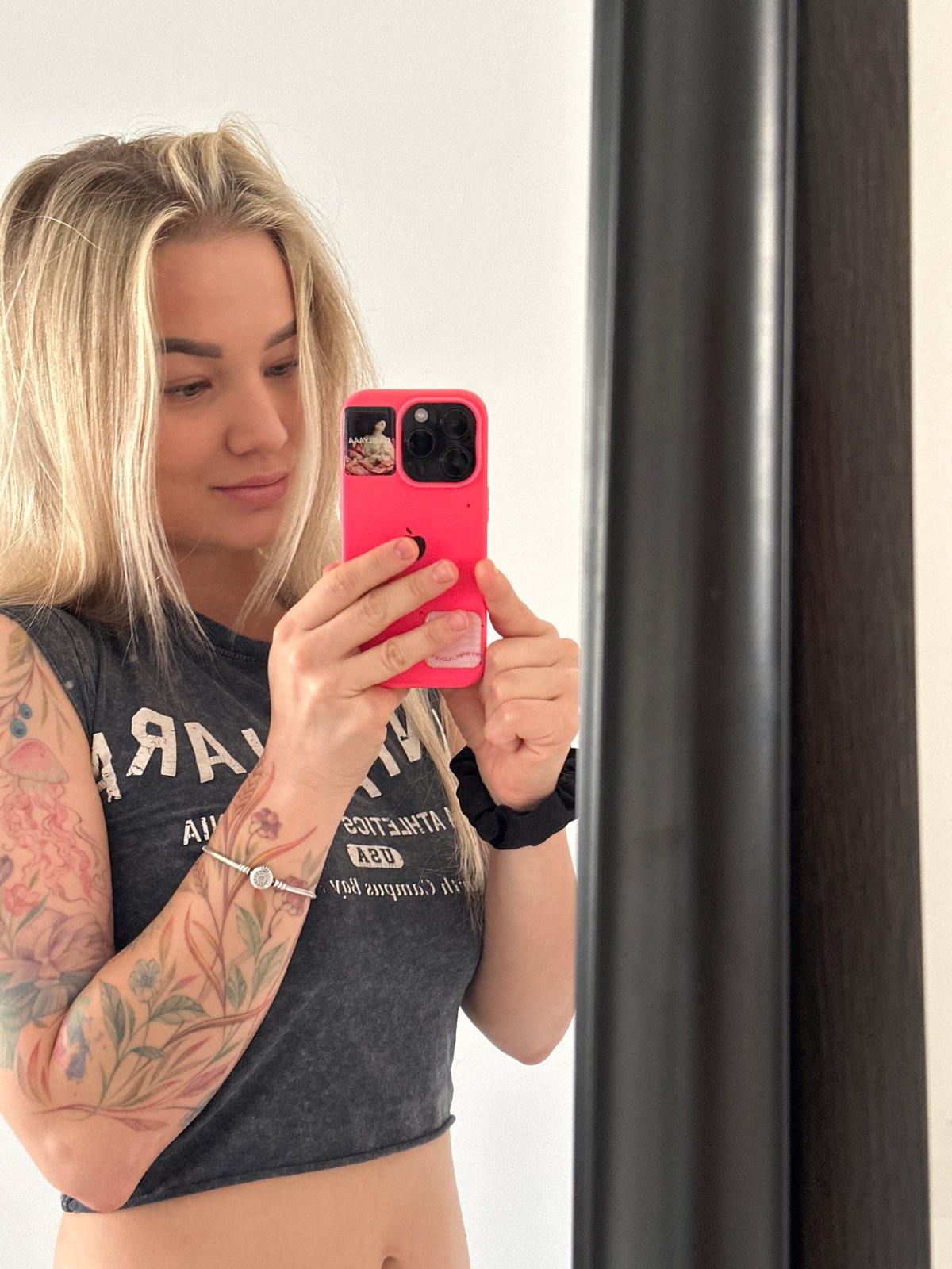 Woman takes multiple mirror selfies in Budva, Montenegro