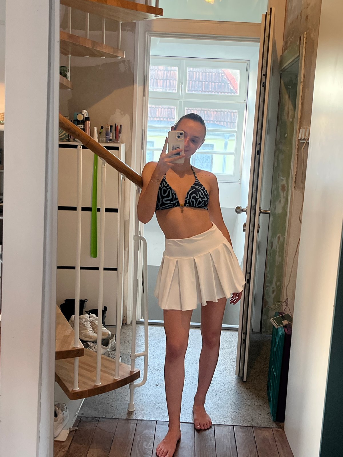 Woman takes selfies around Saarbrücken in white outfit