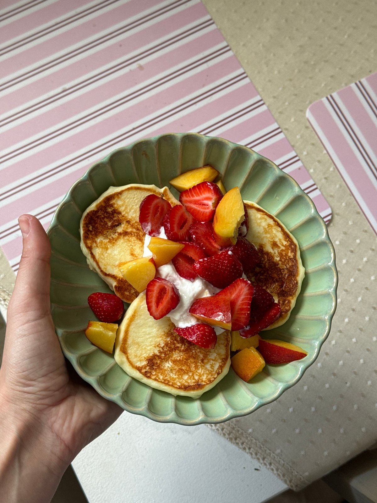 Pancake breakfast with fruit garnish observed in Krasnoyarsk