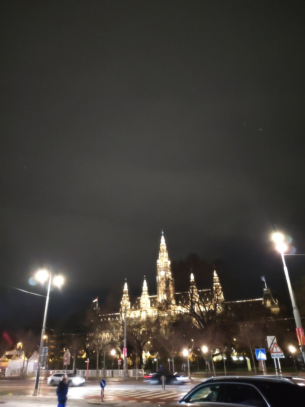 Vienna City Hall illuminated at night with street scene