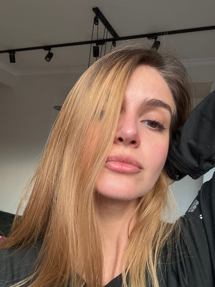 Woman takes multiple selfies in residential setting