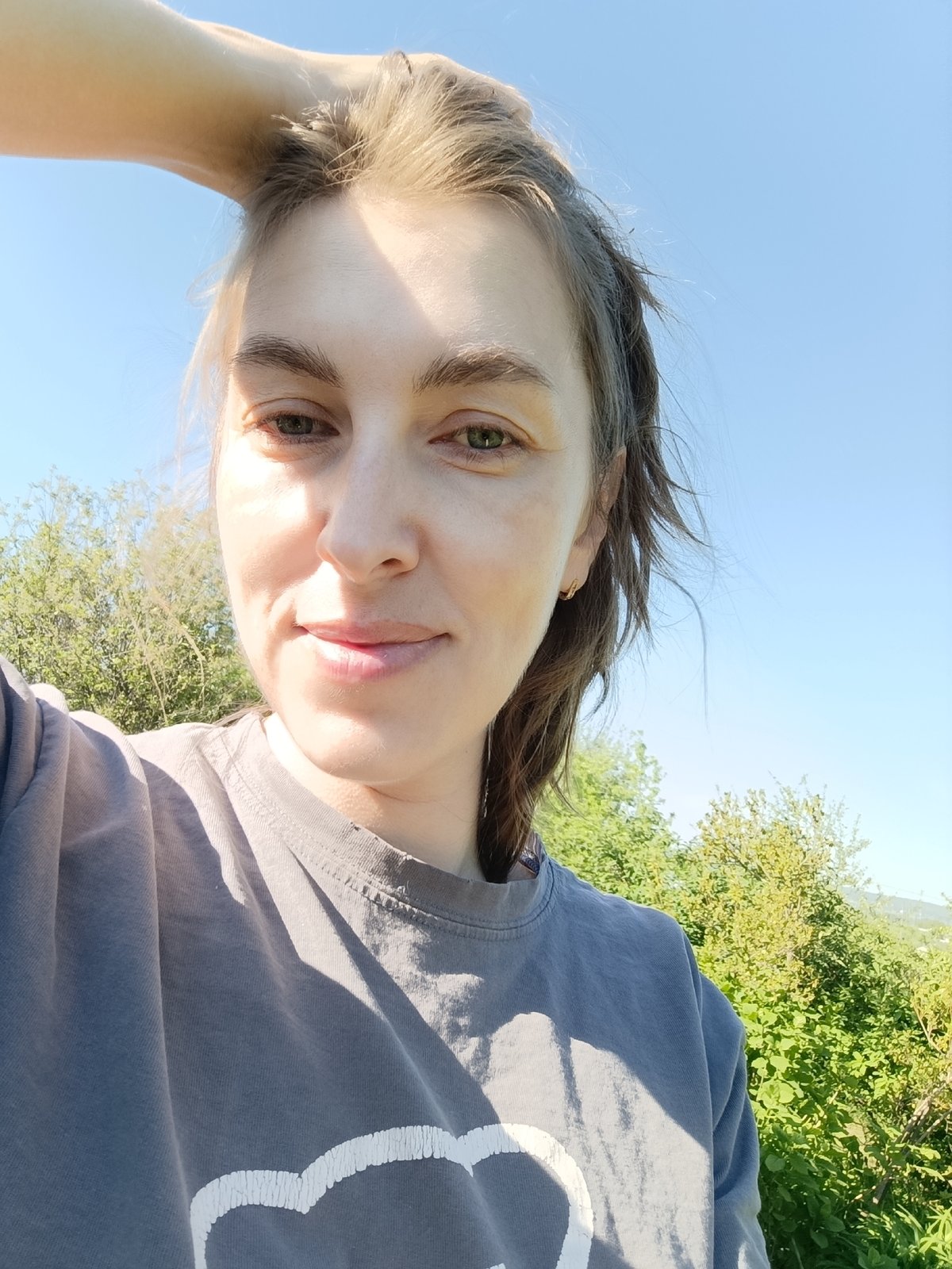 Woman takes sunny morning selfie in Chaikovsky, Russia