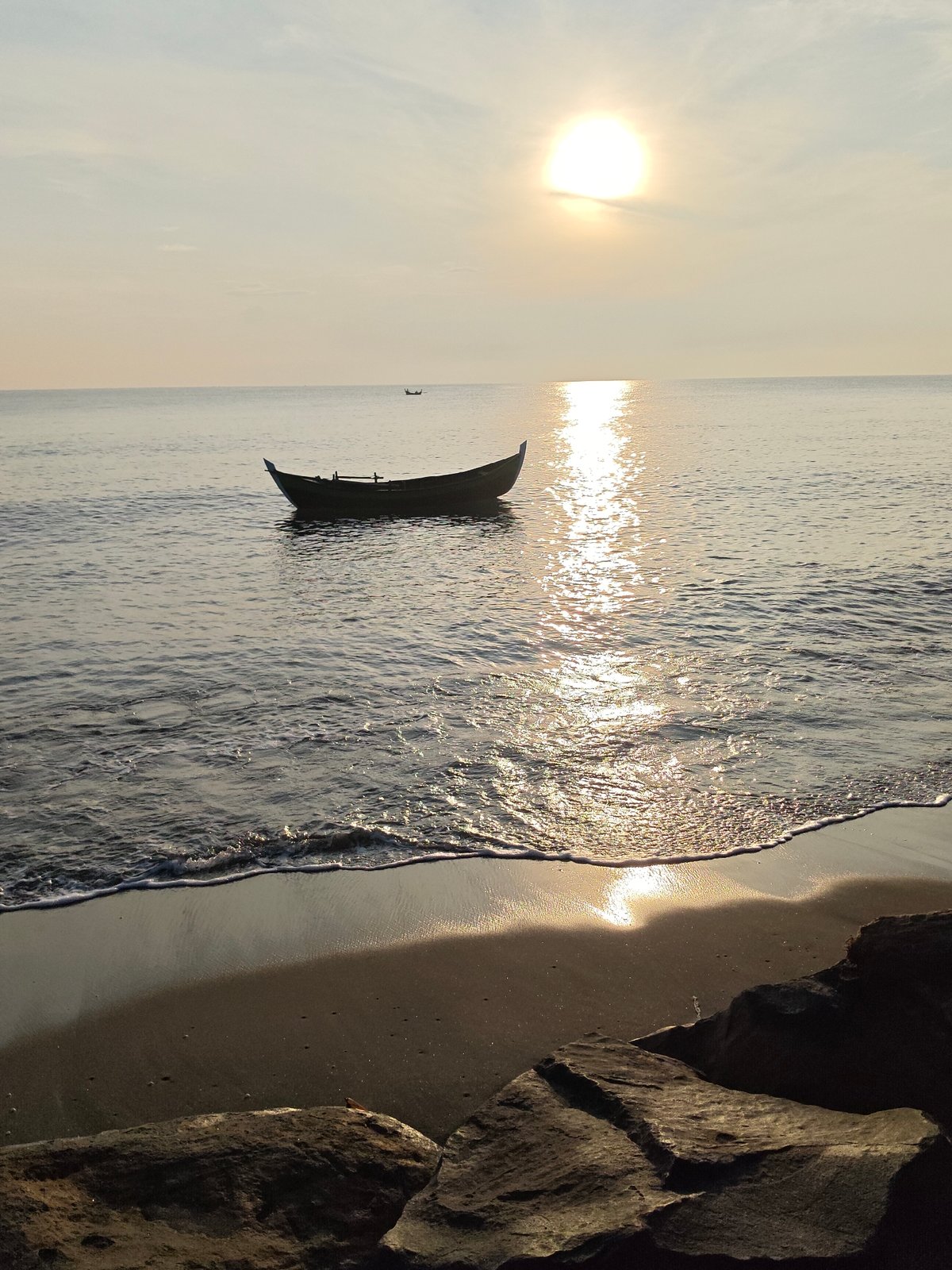 Sunrise fishing boats on calm waters in Lhokseumawe