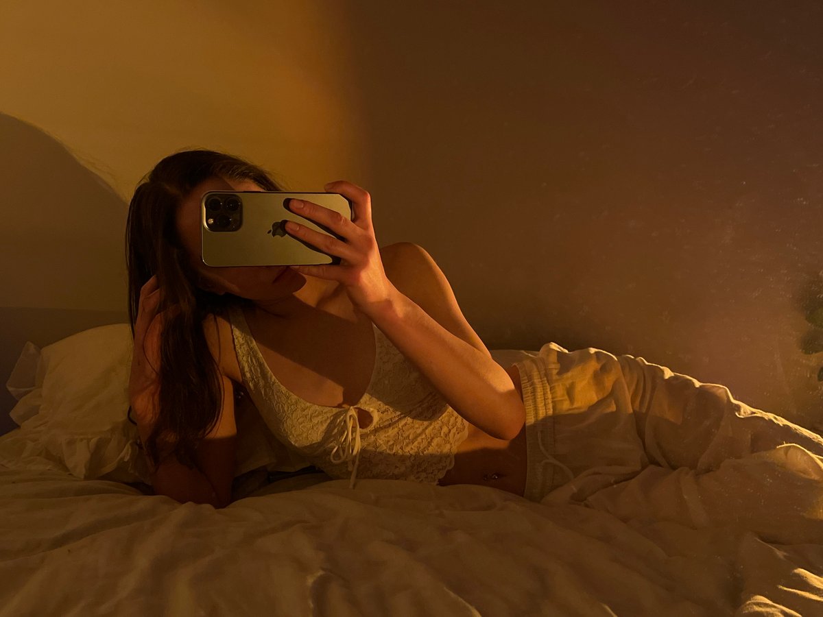 Bedroom selfie session in Ternopil, white lace outfit and soft lighting