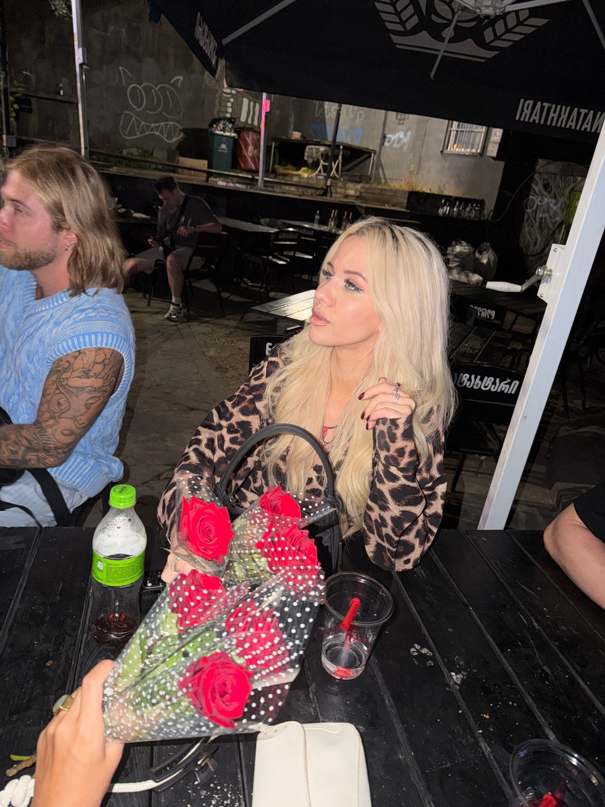 Late-night drinks and red roses at a Tbilisi outdoor cafe