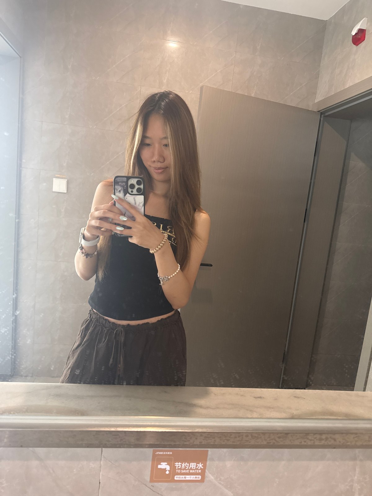 Woman takes extended mirror selfie session in Chongqing bathroom
