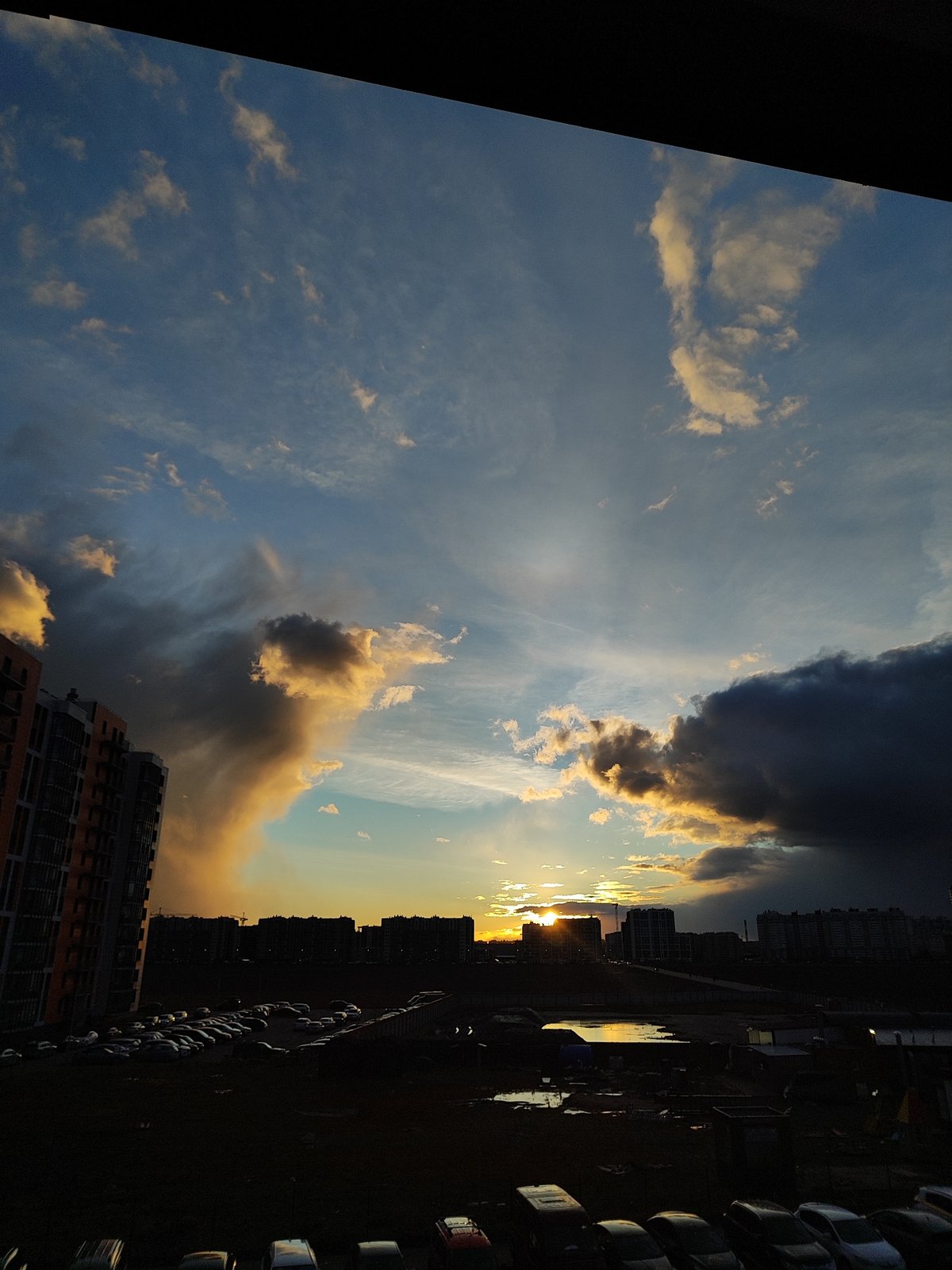 Urban sunset and residential buildings observed from elevated perspective