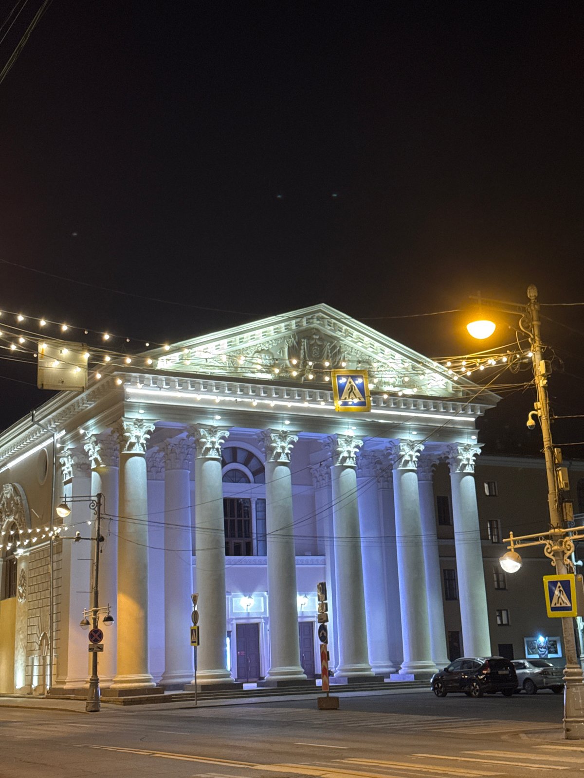 Illuminated classical building observed in evening Tver streetscape