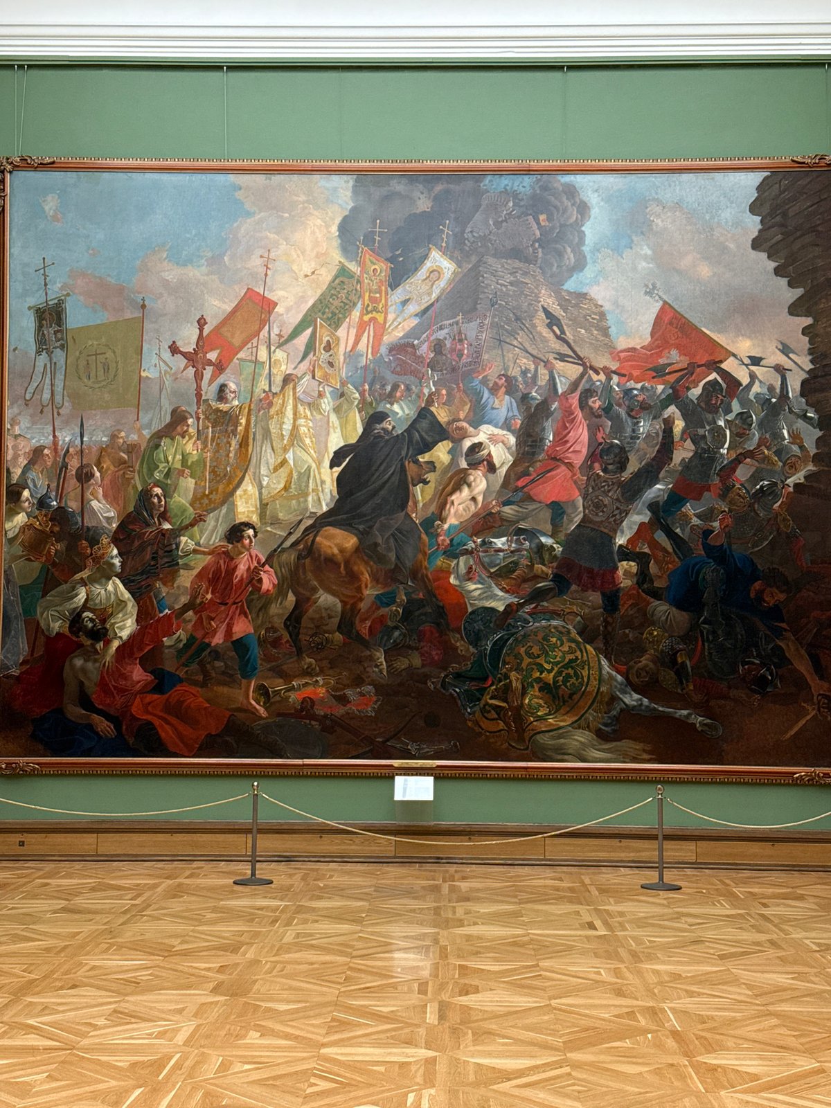 Gallery visitor documents historical paintings and sculptures in Moscow