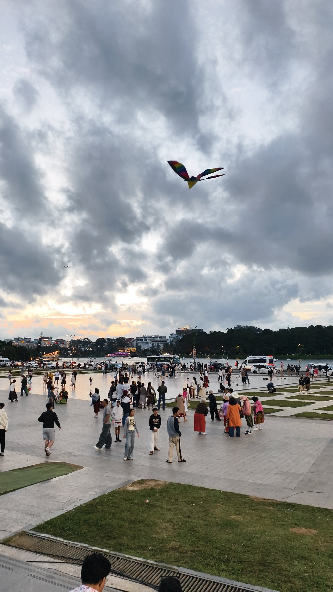 Kite flying and crowds gather at a grand domed plaza