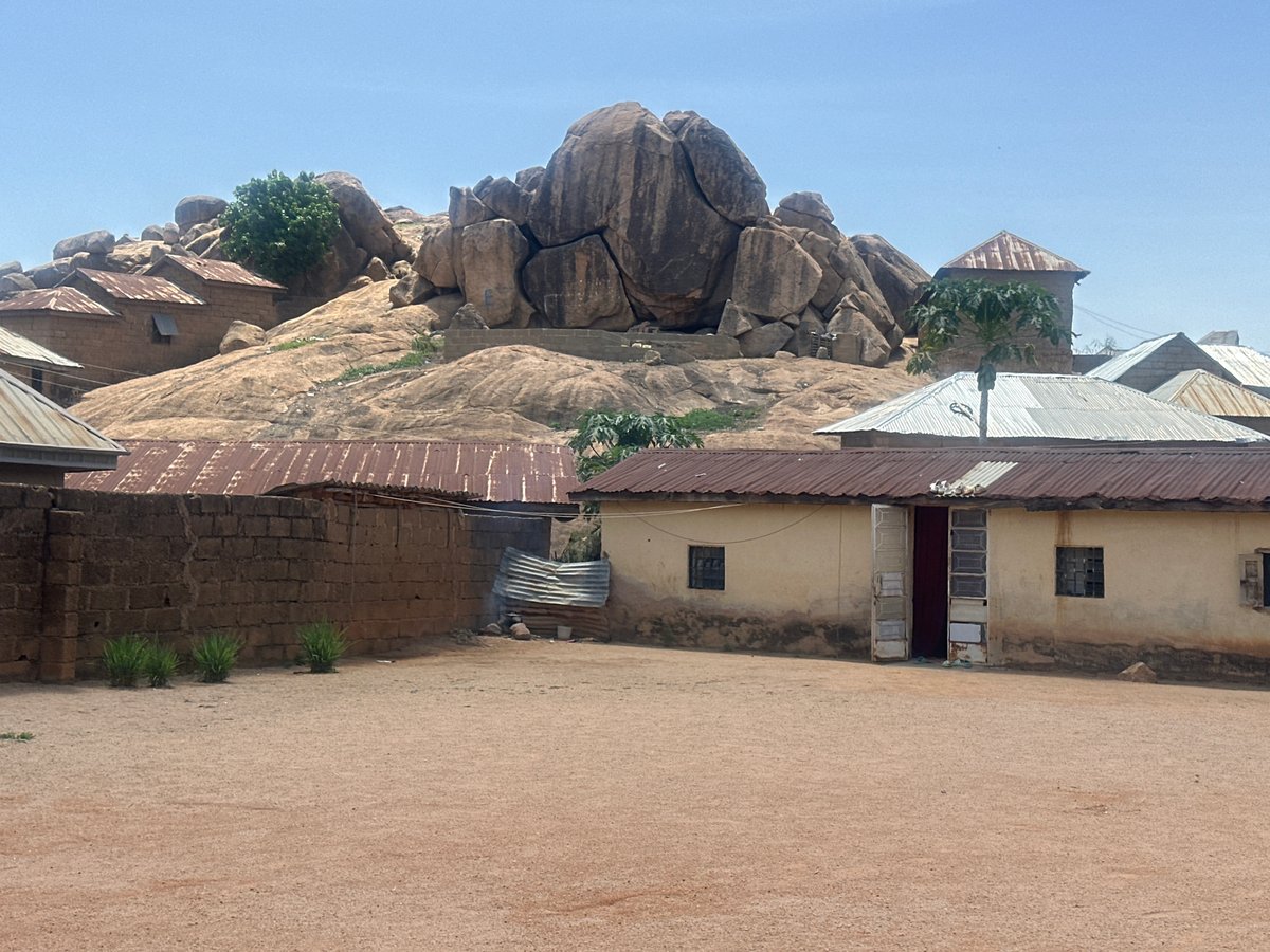 Rural Jos landscape documented showing homes around rocky outcrop