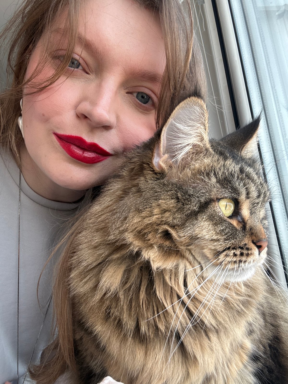 Woman photographed with tabby cat on face in Izhevsk