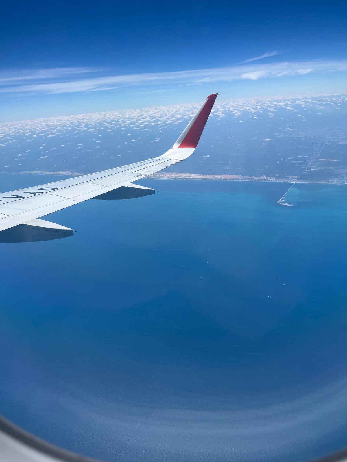 Passenger documents aerial views of Cancún coastline from aircraft