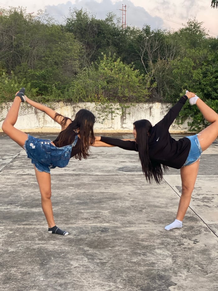 Young adults perform acrobatics during sunset in Juan Griego