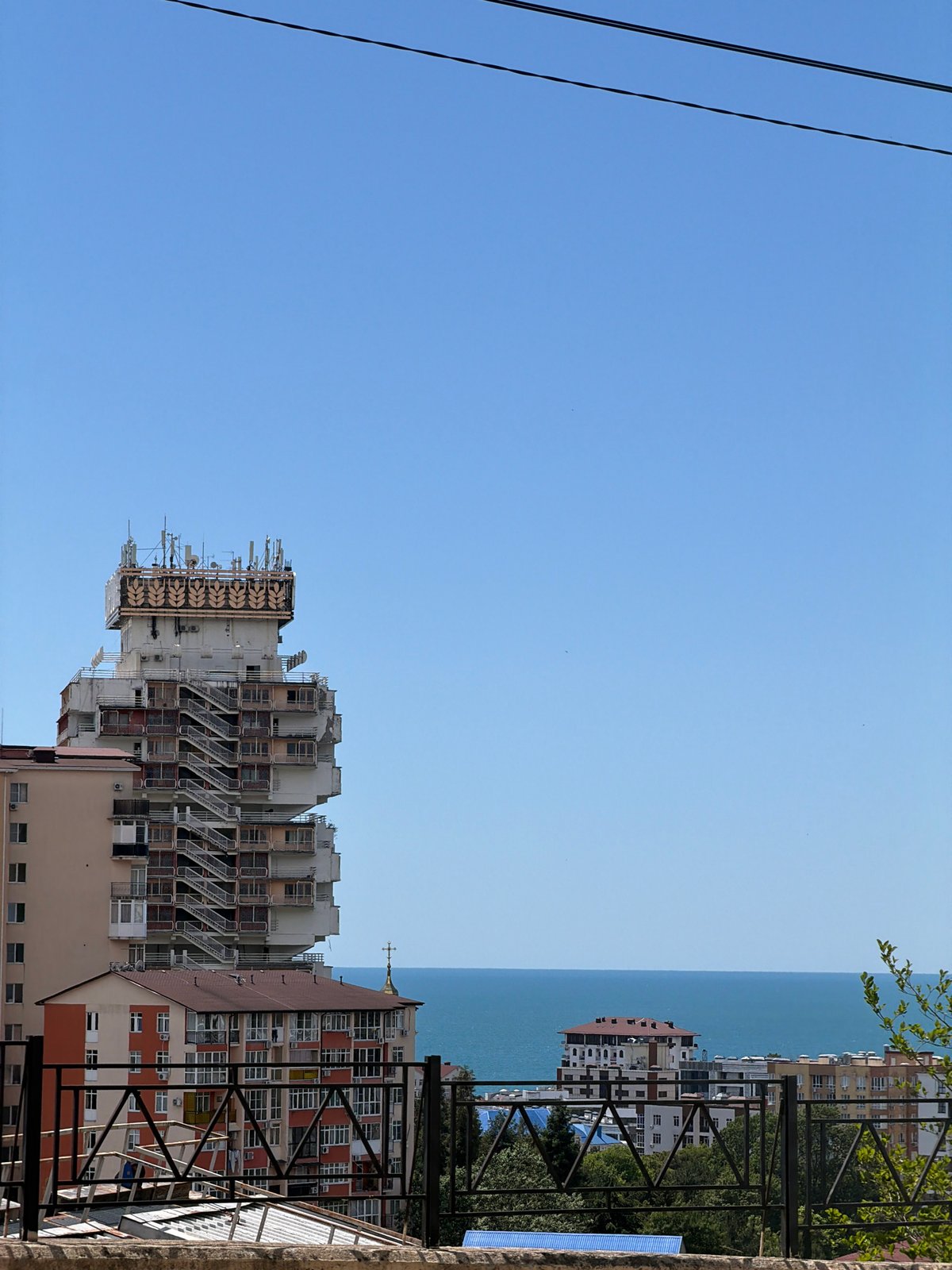 Blue skies and power lines on a sunny Sochi day.