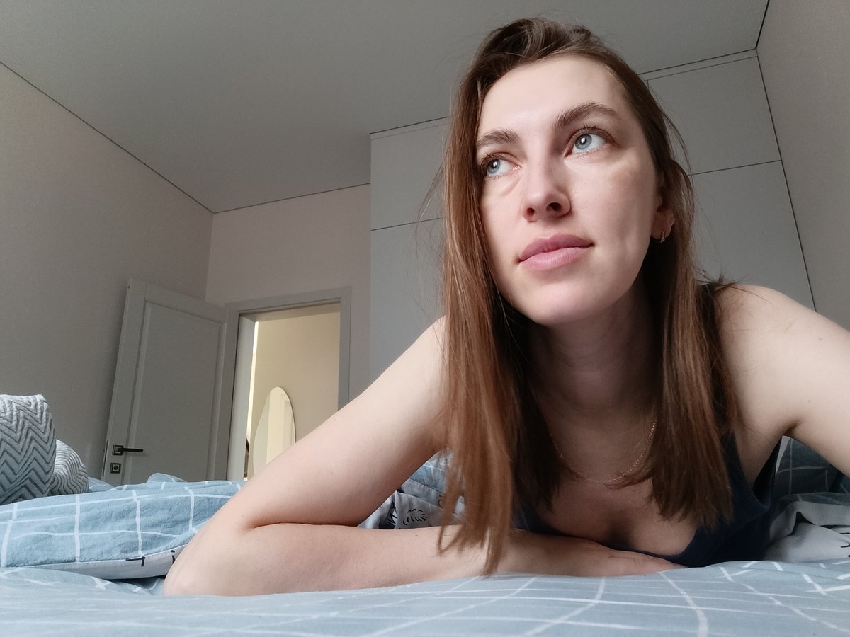 Woman photographed in bedroom during morning hours in Chaikovsky