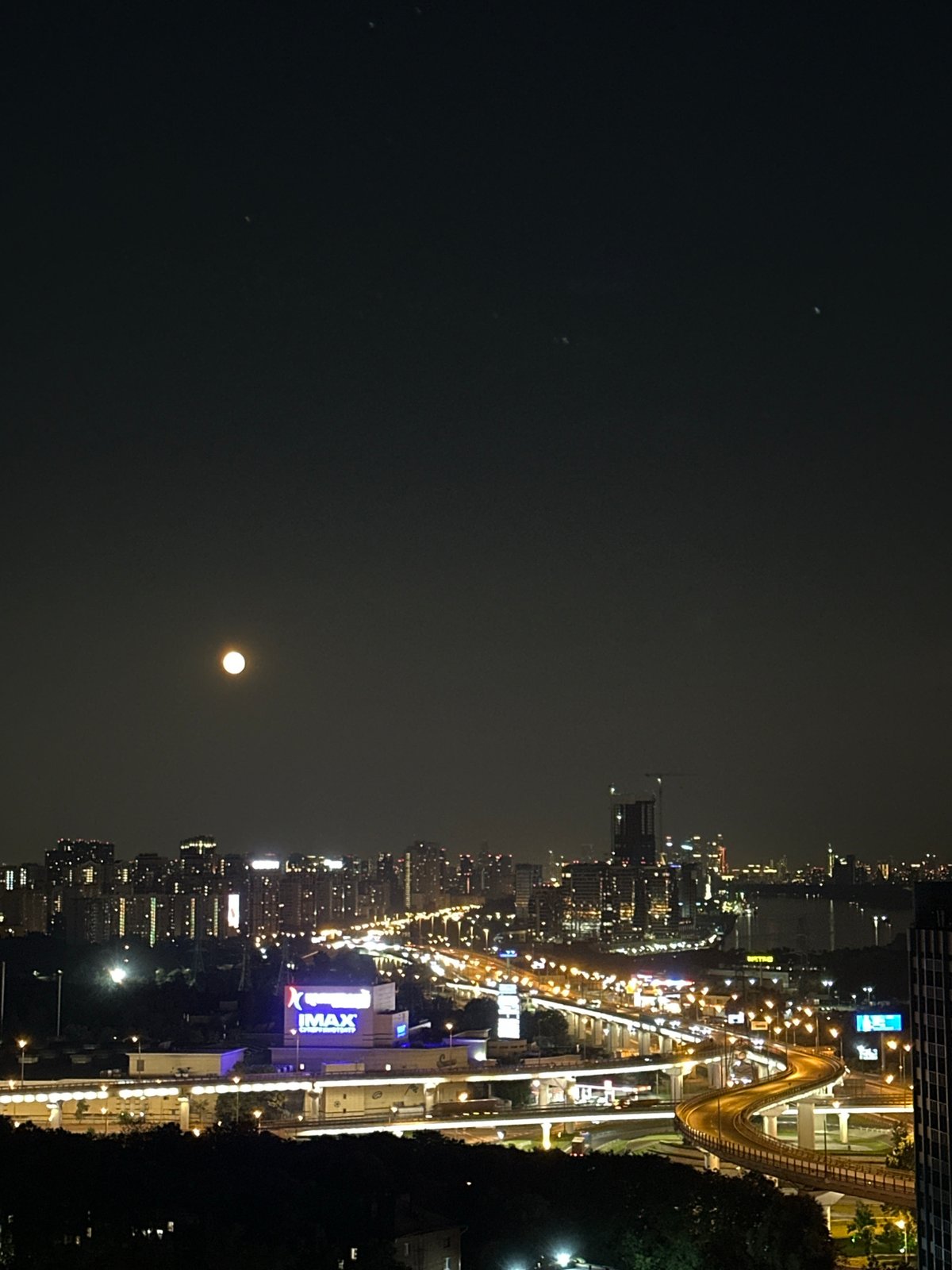 Moscow and Khimki glow under a full moon on a July night
