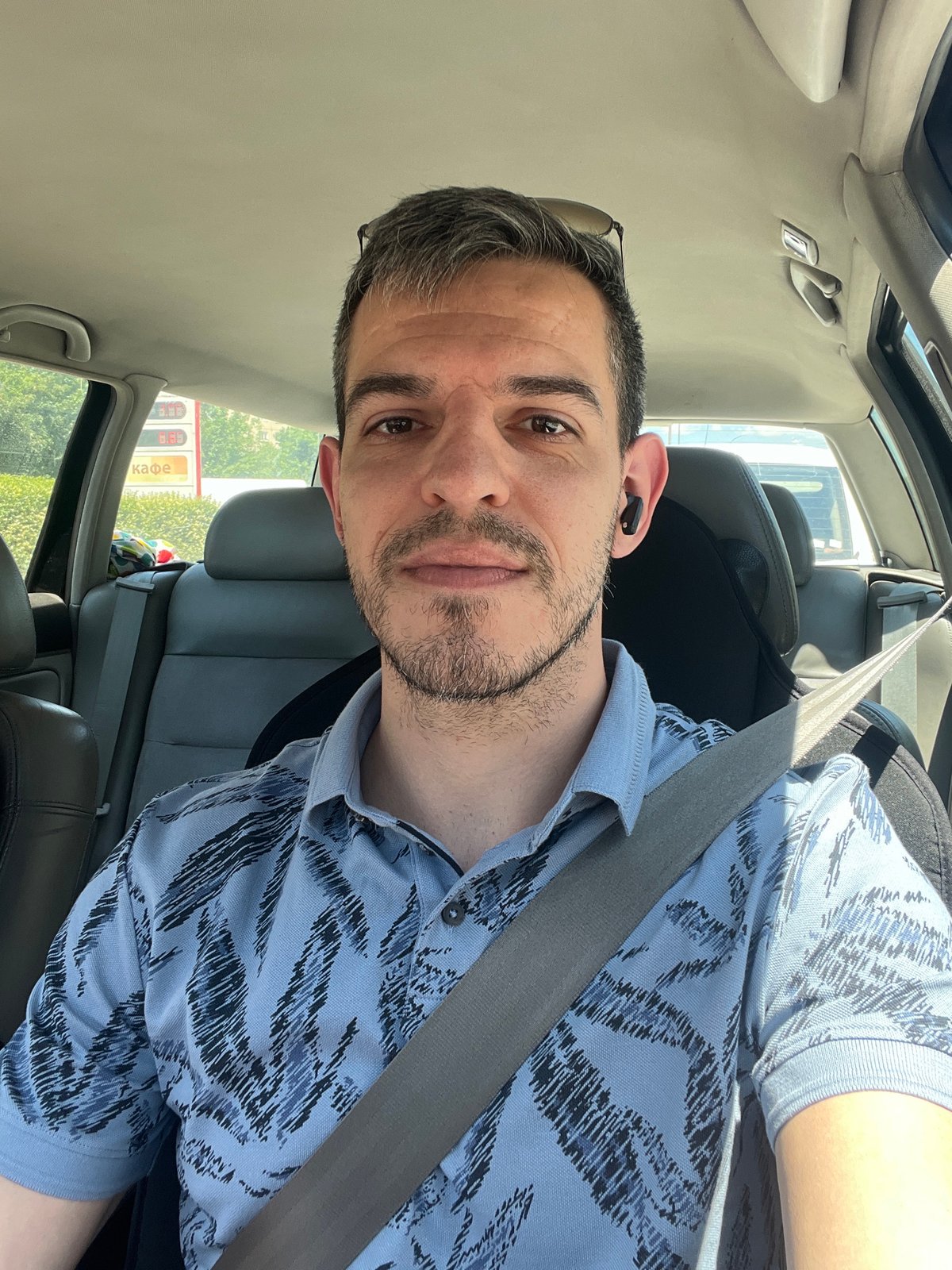 Driver in patterned shirt behind the wheel in Sofia