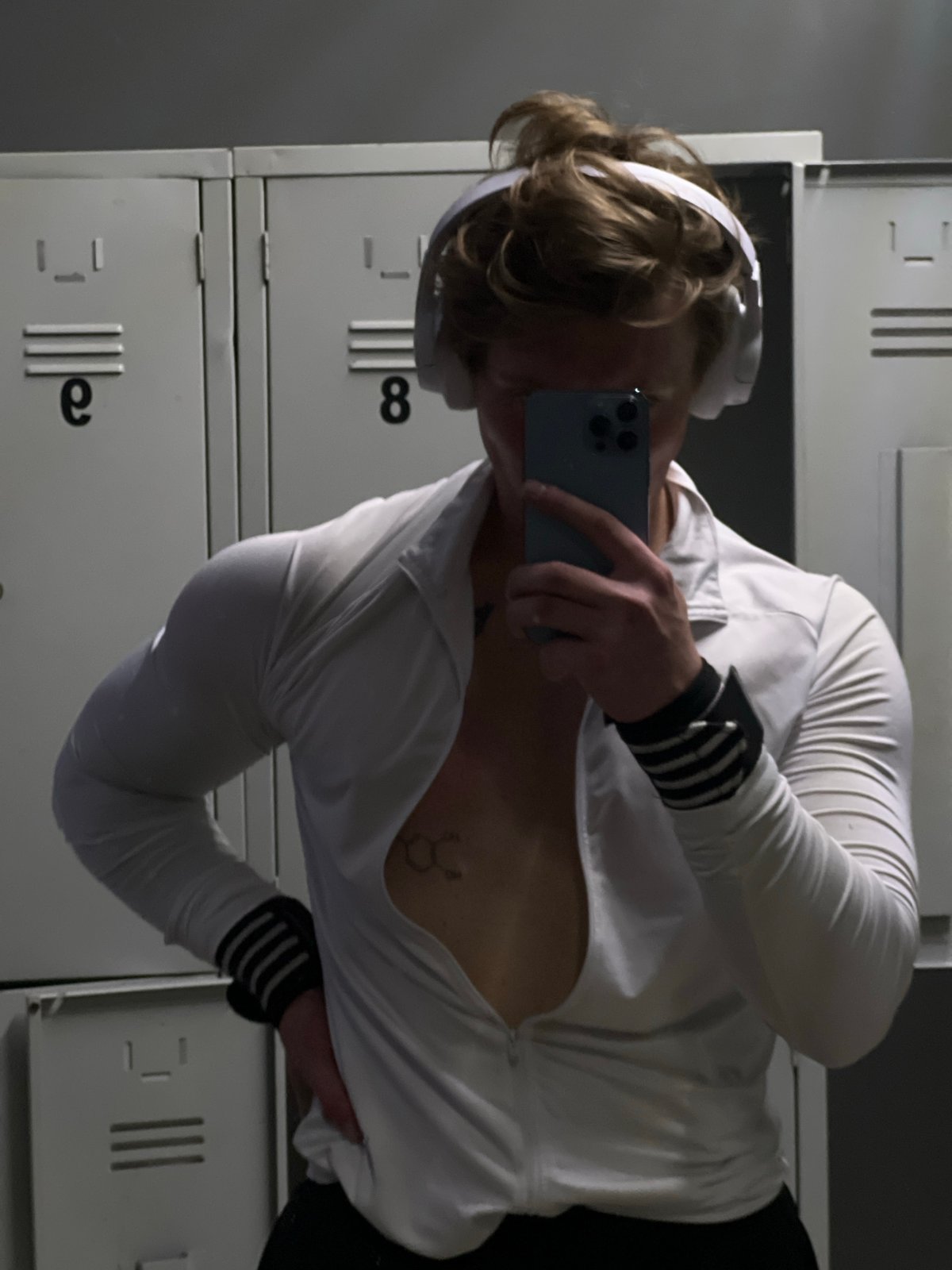 Person takes mirror selfie in locker room