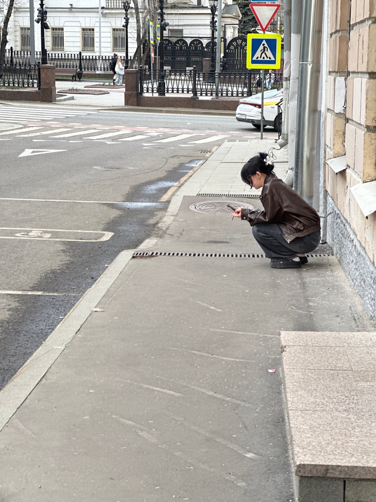 Person spotted squatting on Moscow street curb