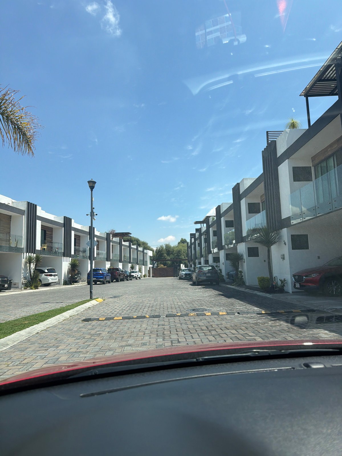 Modern townhouses line residential street in Cholula, Mexico