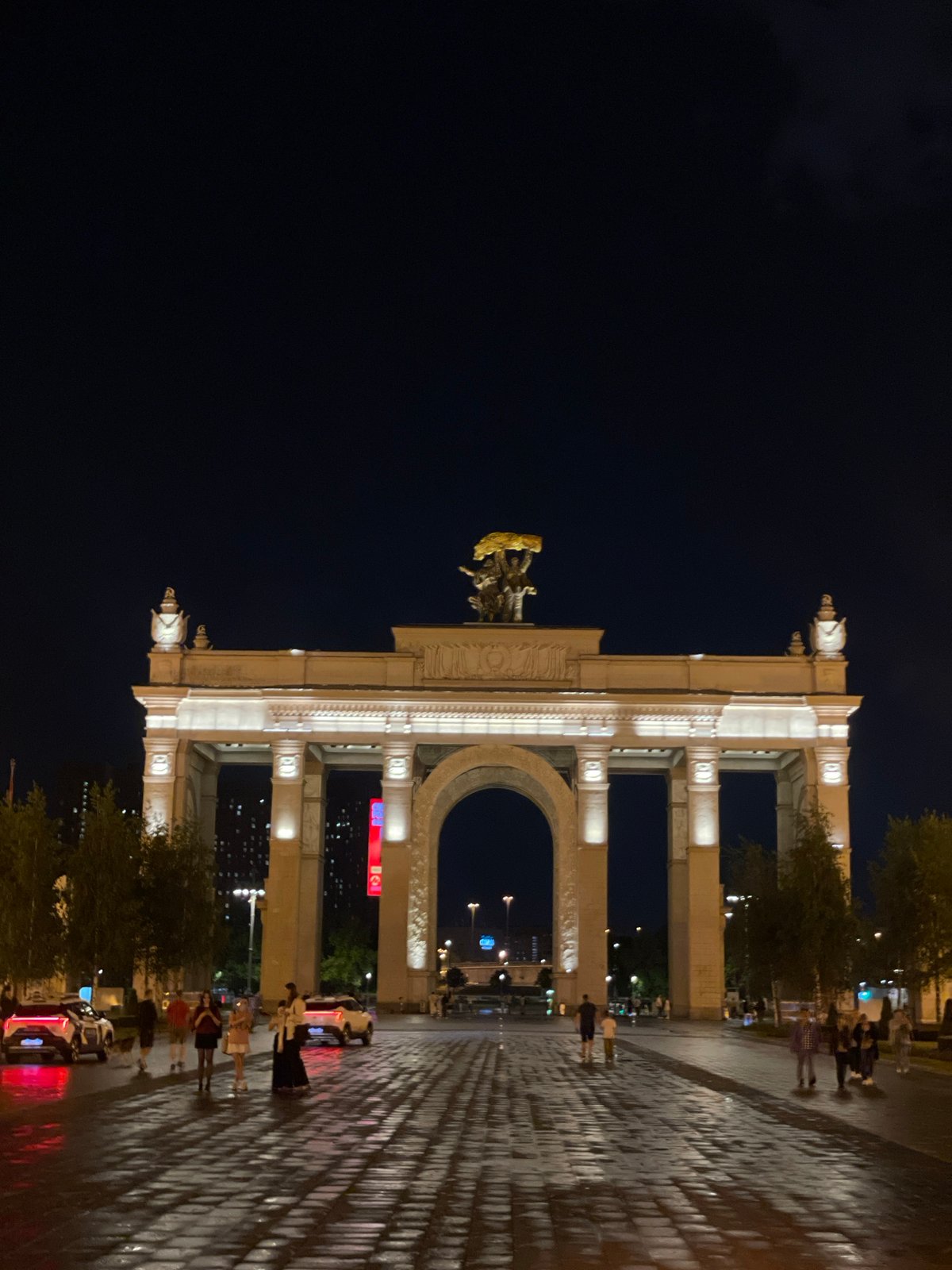 Moscow's Triumph Arch illuminated during evening hours