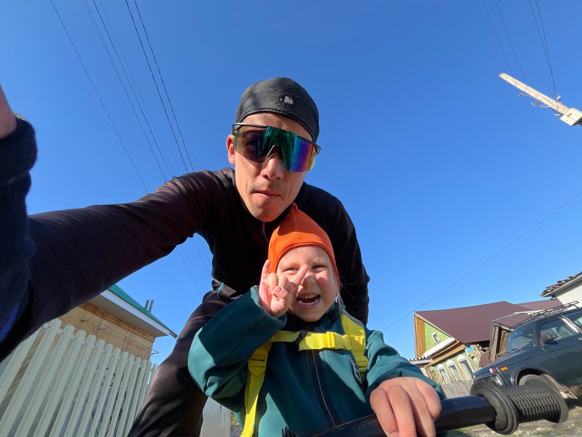 Father and child enjoy sunny afternoon bike lesson in Chaikovsky