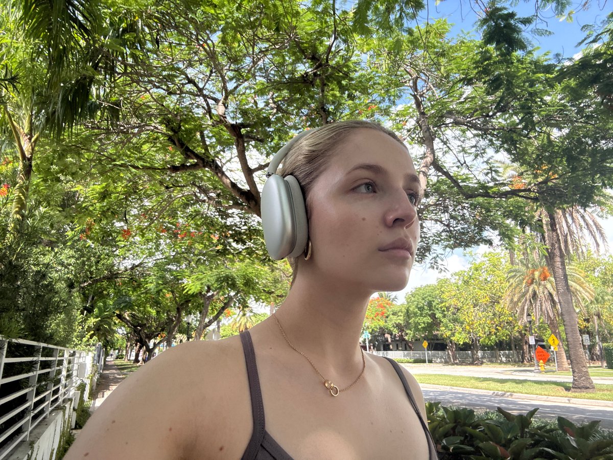 Selfie stop mid-walk on a sunny Miami street