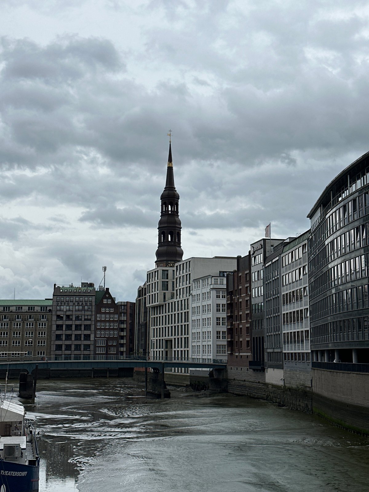 Tourist documents overcast Hamburg waterfront and Gothic architecture