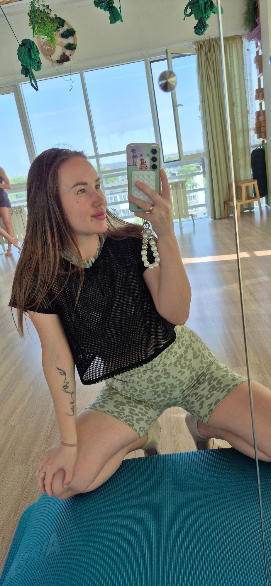 Woman documents meditation studio selfie session early morning
