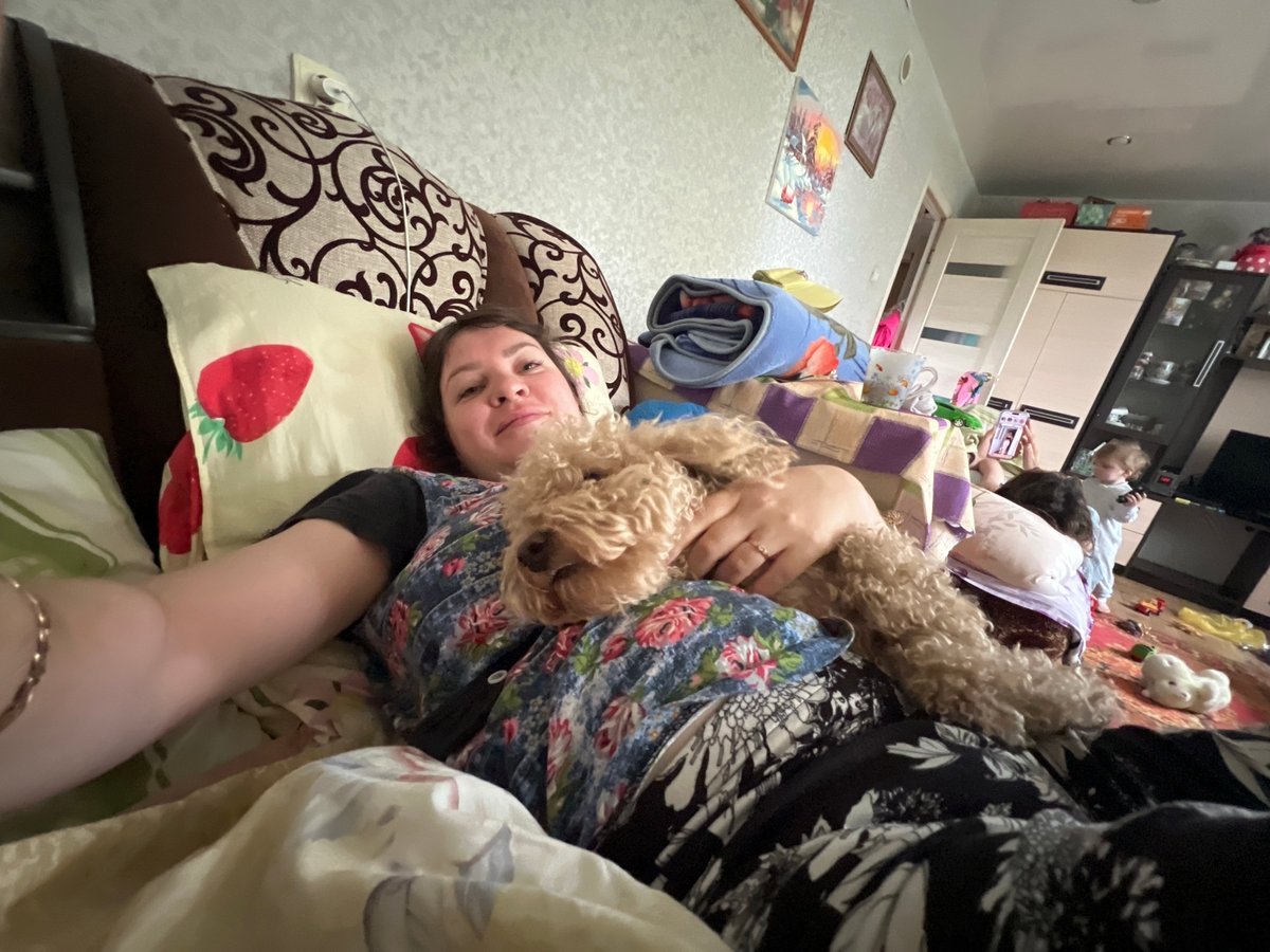Family shares quiet morning moments with poodle in Russian home
