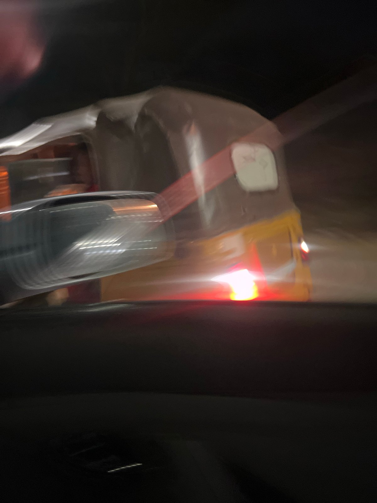 Yellow tricycle captured in motion during nighttime in Abuja