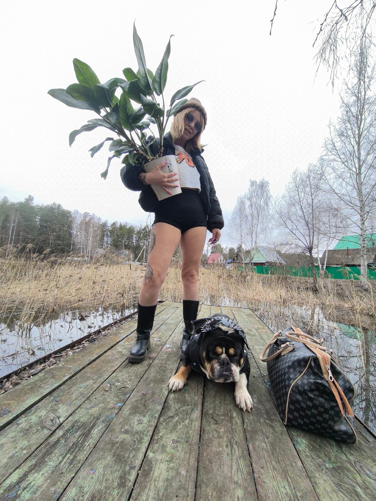 Woman and costumed English Bulldog spotted on rural Russian dock
