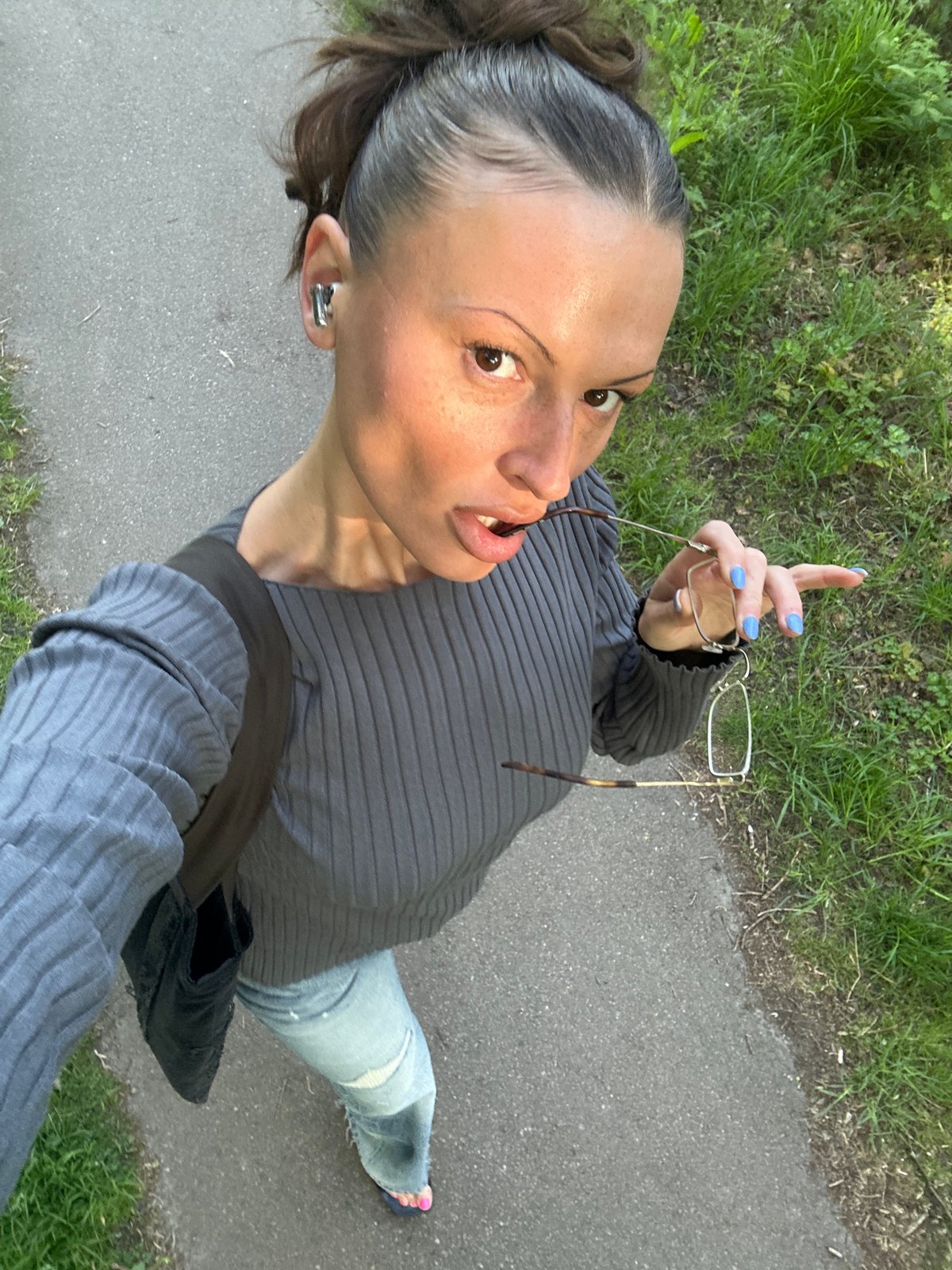 Woman enjoys spring morning walk, dandelion moment in Tunbridge Wells
