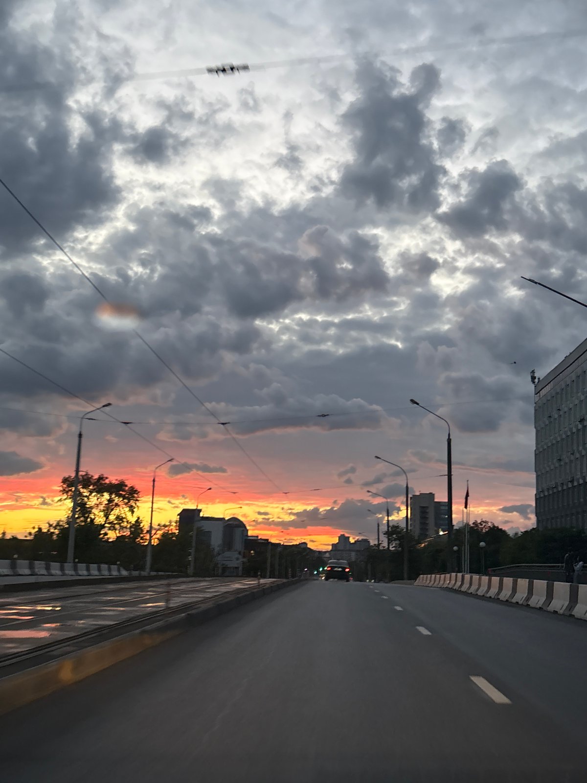 Taxi stops at traffic light during stormy sunset in Minsk
