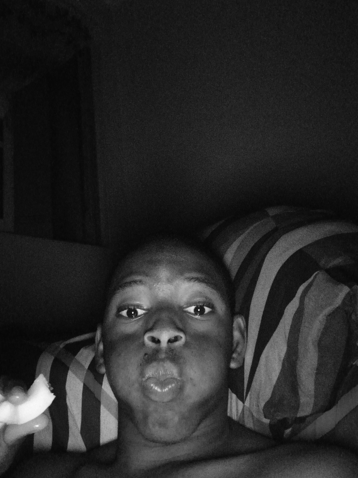 Person photographed eating in bed in Lagos