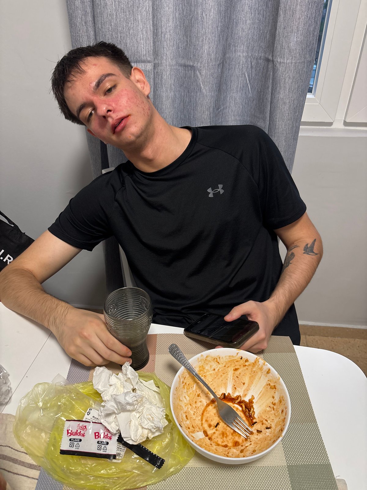 Young man enjoys spicy Korean ramen in Plovdiv dining area