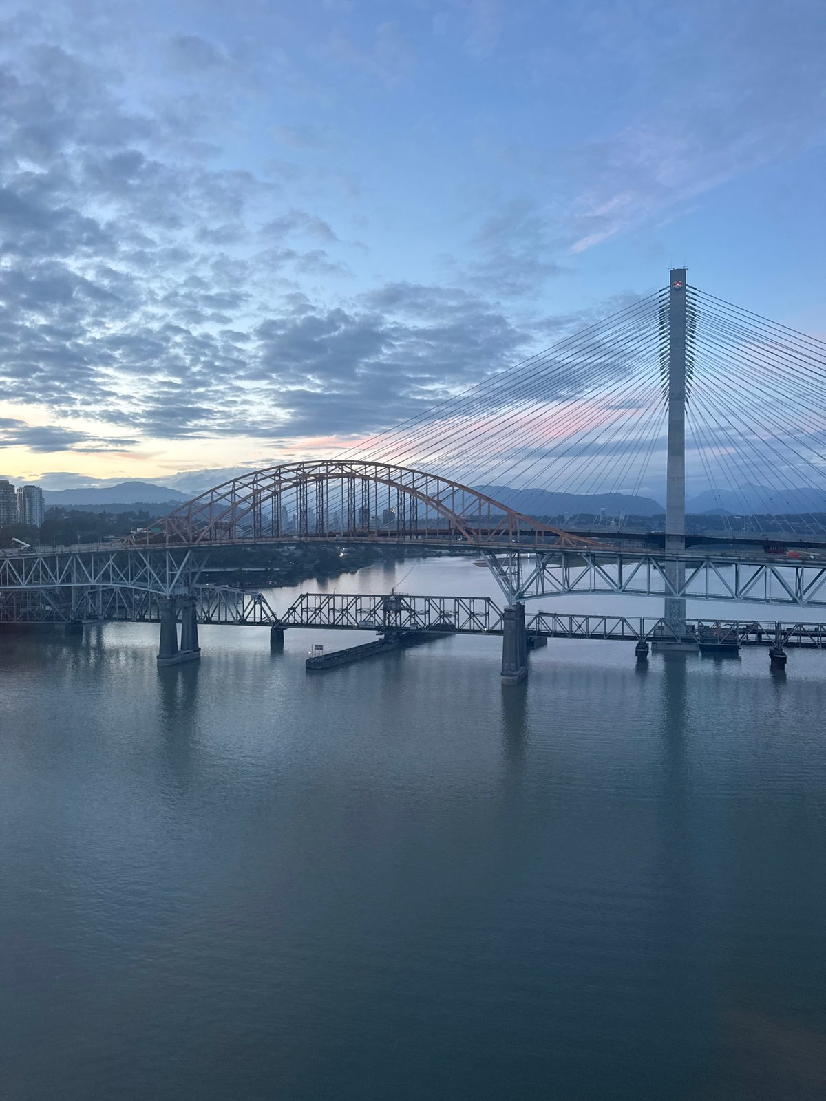Fraser River at dawn, three bridges stretching across the water