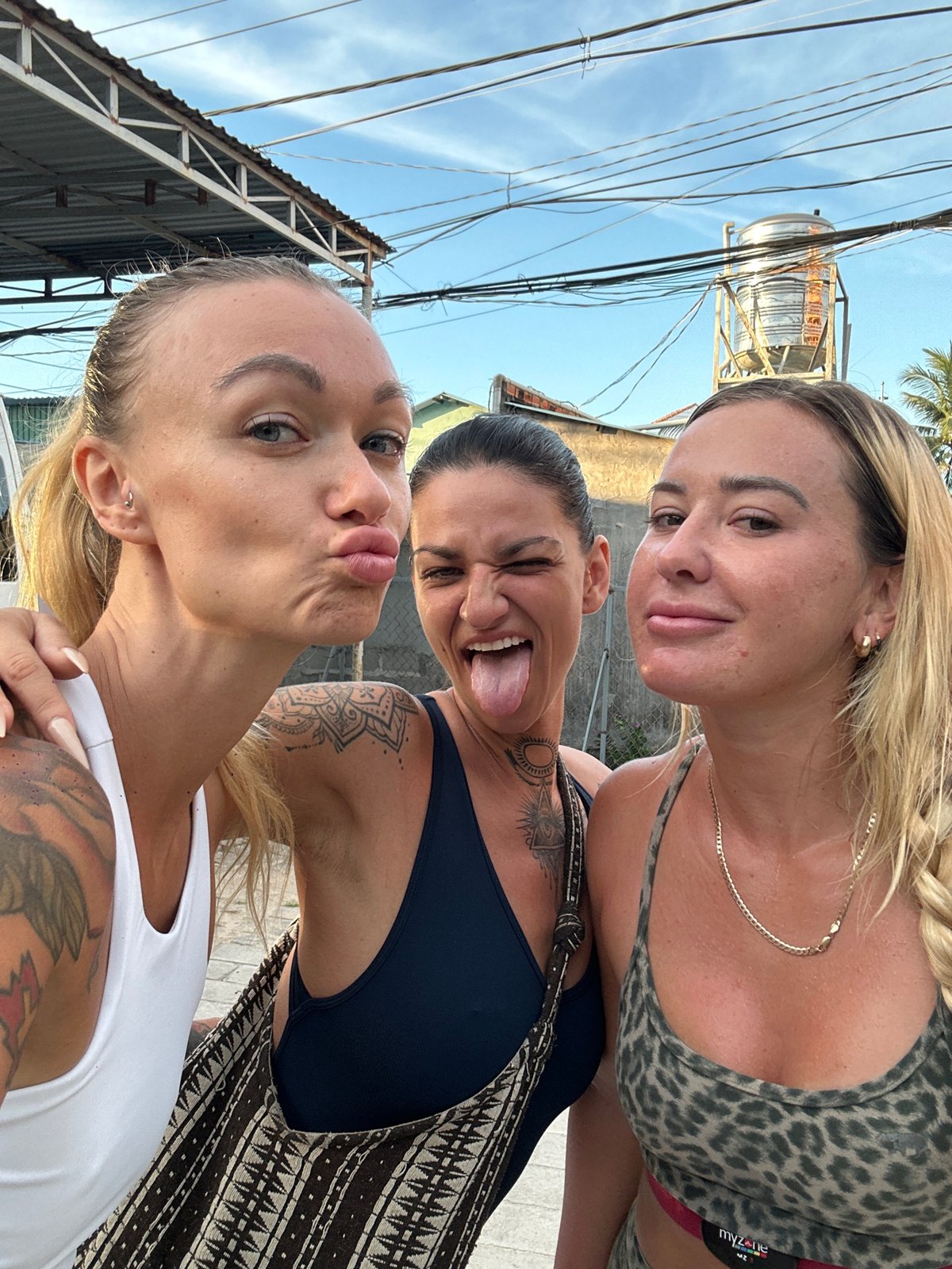 Group workout and selfies on a palm-lined courtyard in Mũi Né