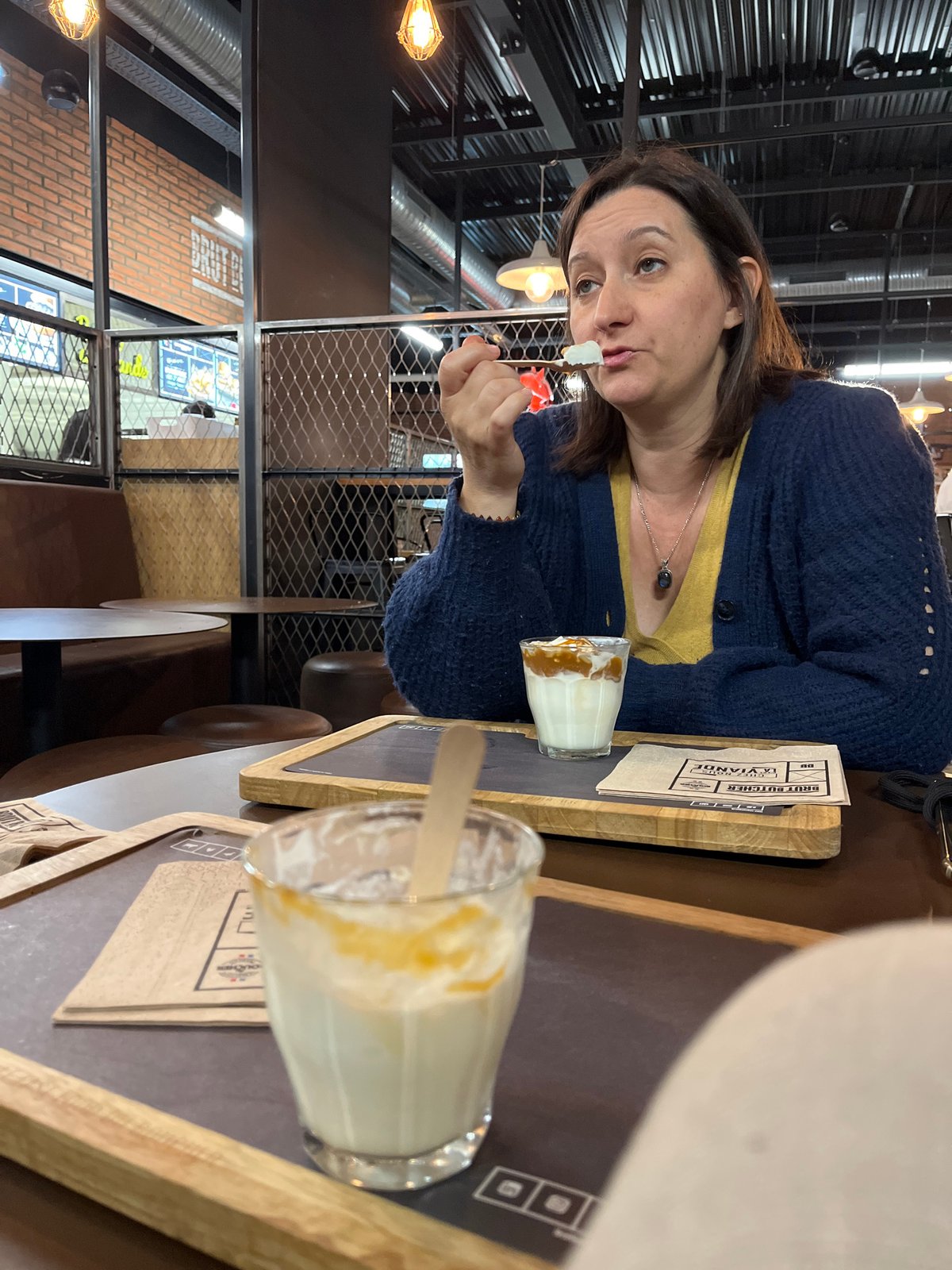 Woman enjoys dessert in Andrézieux-Bouthéon dining moment