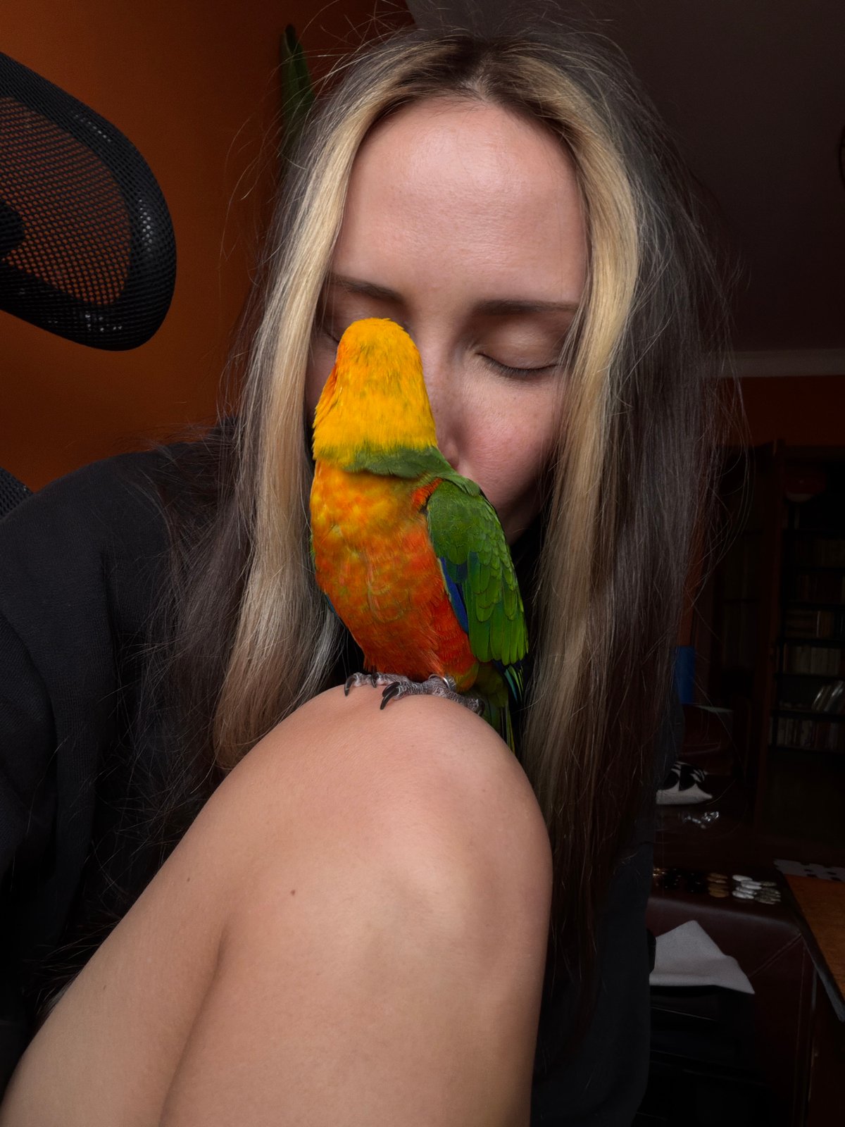 Woman and colorful parrot share intimate moments in Khimki