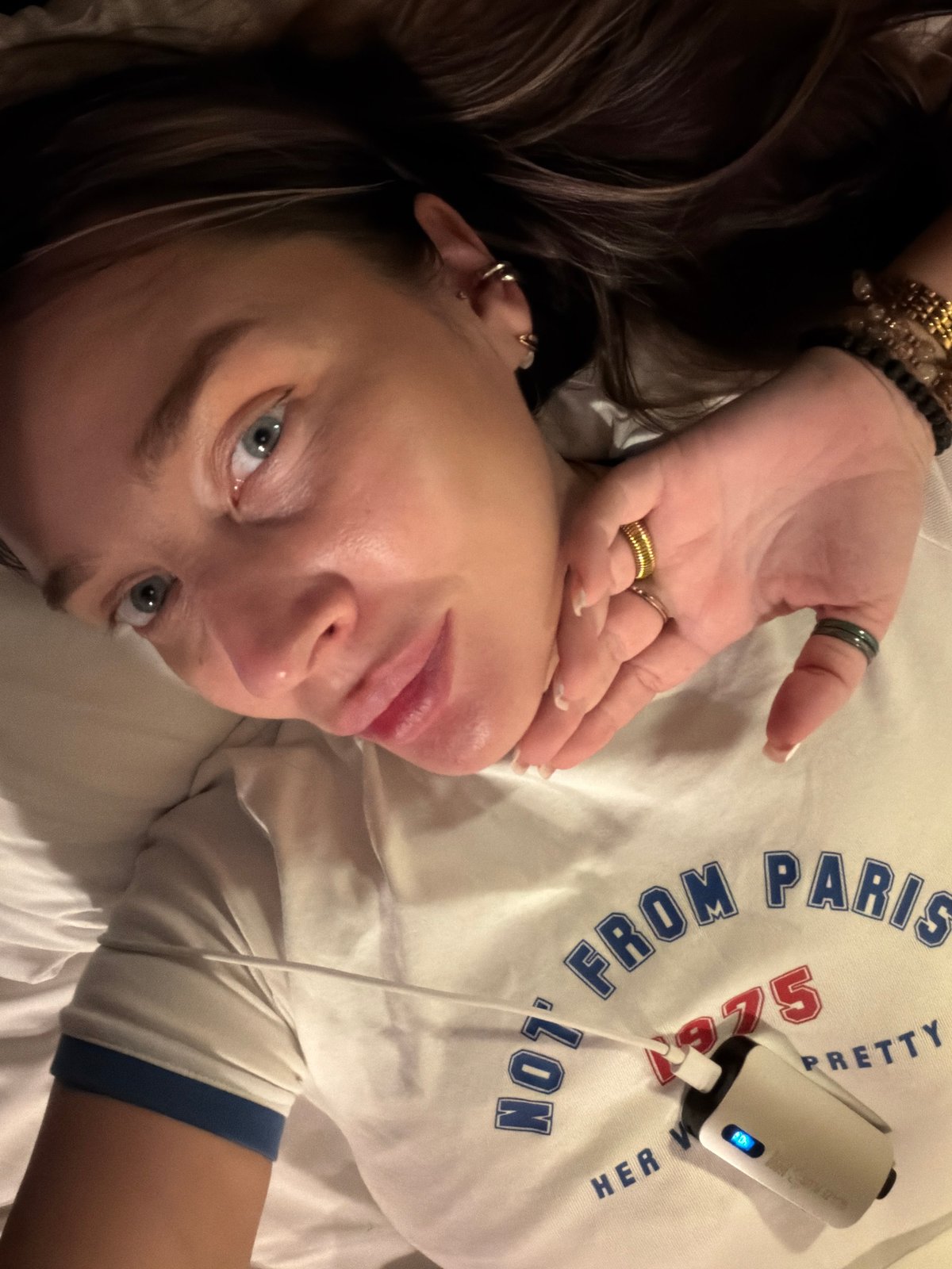 Woman in white t-shirt photographed on bed in Moscow