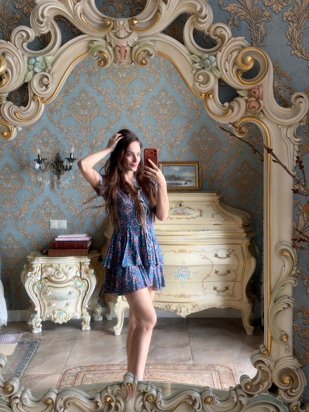Indoor selfie session in Ufa featuring a blue floral dress