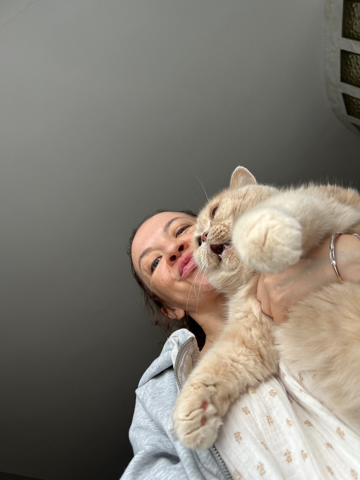 Woman shares morning moments with cat and child in Chaikovsky