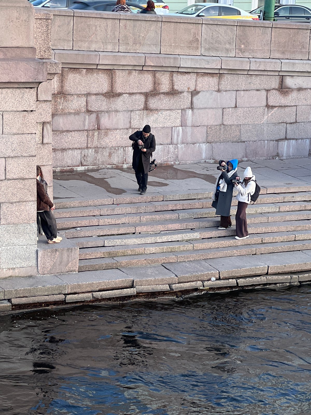 Photo session held on Neva River steps in Saint Petersburg
