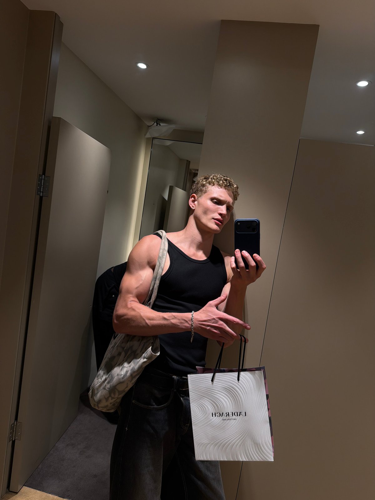 Changing room selfie with a marble-pattern bag, London